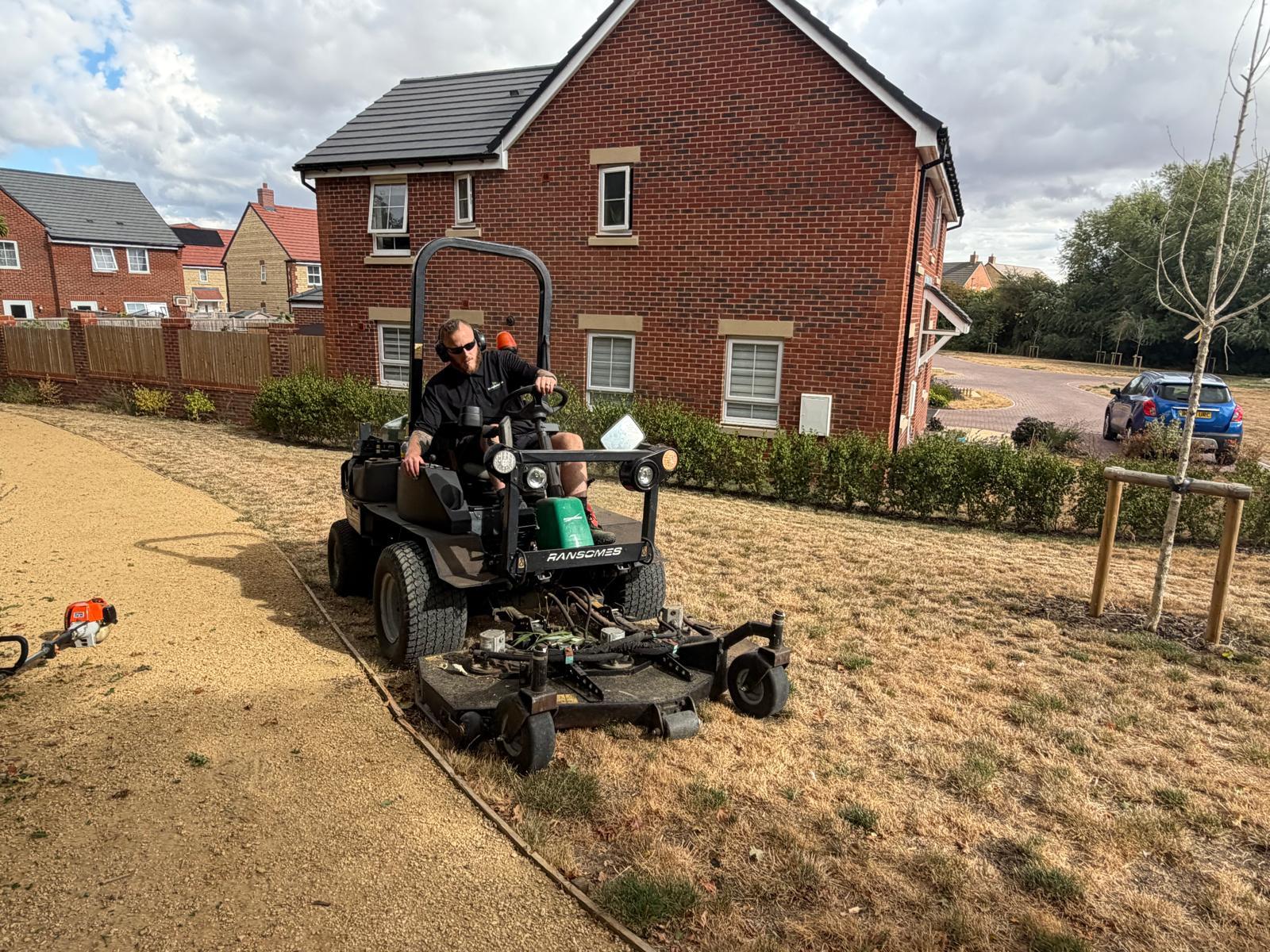 HumphriesTrio operator mowing communal grounds on a managed development